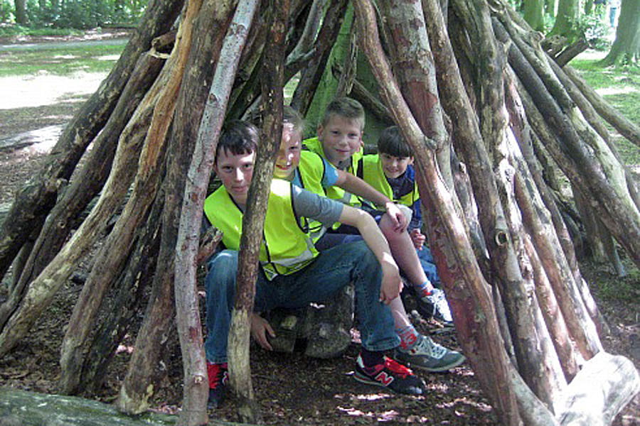 jongens spelen in het huttenbos in het haagse bos